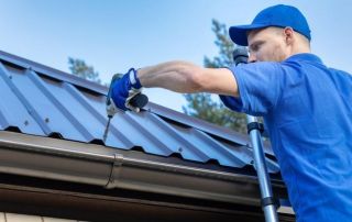 Roofing Sites in College Station, TX - Image of a roofer working on a metal roof